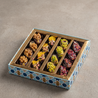 Assorted flavoured stuffed dates gift box on a stone surface