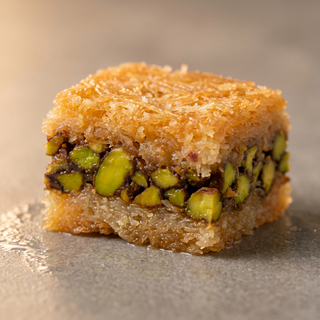Pistachio kunafa cut to show the crisp kataifi strands and pistachio, macro