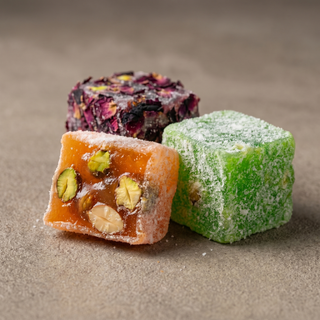 Turkish delight cubes, one cut to show the jelly and nuts, macro