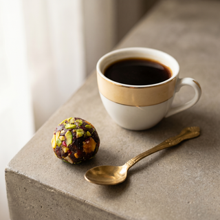 Assorted Indian Fusion Sweets beside a coffee cup showing size