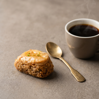 Rosebud Baklava beside a coffee cup showing size