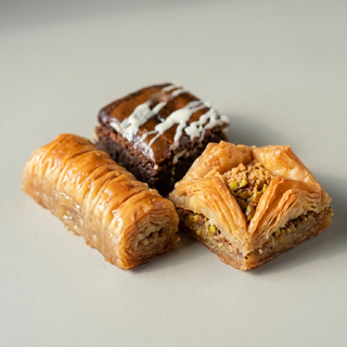 Close-up of assorted baklava pieces with crisp phyllo and pistachio